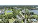 Scenic aerial view of a residential neighborhood, trees, pond and partial waterway at 751 Bayshore Dr, Tarpon Springs, FL 34689
