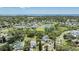 Expansive aerial view showcasing homes nestled within a verdant landscape, complemented by a serene pond at 751 Bayshore Dr, Tarpon Springs, FL 34689