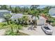 Stunning aerial view showcasing a lovely single story home with a brick driveway and lush tropical landscaping at 751 Bayshore Dr, Tarpon Springs, FL 34689