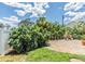 Brick back patio area with lush landscaping and chair seating at 751 Bayshore Dr, Tarpon Springs, FL 34689