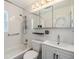 Clean bathroom featuring tub, tiled walls, updated sink, and medicine cabinet at 751 Bayshore Dr, Tarpon Springs, FL 34689