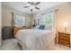 Comfortable bedroom with large windows, tiled floors, and ceiling fan at 751 Bayshore Dr, Tarpon Springs, FL 34689