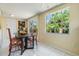 Bright dining area features tile floors, large windows, and dining table with seating for four at 751 Bayshore Dr, Tarpon Springs, FL 34689