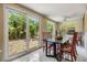 Bright dining area features tile floors, large windows, and sliding glass doors to a brick patio with lush landscaping at 751 Bayshore Dr, Tarpon Springs, FL 34689