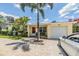 Charming single story home with a brick driveway, lovely landscaping, and a one car garage at 751 Bayshore Dr, Tarpon Springs, FL 34689