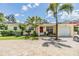 Charming single story home with a brick driveway, lush landscaping, and a one car garage at 751 Bayshore Dr, Tarpon Springs, FL 34689