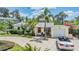 Charming single story home with a brick driveway, lush landscaping, and a one car garage at 751 Bayshore Dr, Tarpon Springs, FL 34689