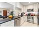 Bright and modern kitchen with white cabinetry, stainless steel appliances, and black countertops at 751 Bayshore Dr, Tarpon Springs, FL 34689