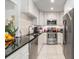 Modern kitchen featuring stainless steel appliances, white cabinets, and sleek countertops at 751 Bayshore Dr, Tarpon Springs, FL 34689