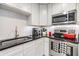 Well-lit kitchen featuring white cabinets and stainless steel appliances at 751 Bayshore Dr, Tarpon Springs, FL 34689