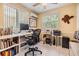 Office space with tiled floors, desk, ceiling fan, and storage space at 751 Bayshore Dr, Tarpon Springs, FL 34689