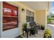 Close-up of charming porch area featuring a bench, plants, and an outdoor light fixture at 751 Bayshore Dr, Tarpon Springs, FL 34689