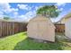Backyard shed with green grass and a wood fence in the background at 7841 Royal Stewart Dr, New Port Richey, FL 34653