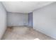 Finished basement area with grey carpet and light grey painted walls at 7841 Royal Stewart Dr, New Port Richey, FL 34653