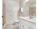 Bathroom features a toilet, shower, vanity with white cabinets, and a large mirror at 7841 Royal Stewart Dr, New Port Richey, FL 34653