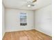 Bedroom features light wood floors, one window, and a ceiling fan at 7841 Royal Stewart Dr, New Port Richey, FL 34653