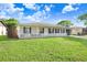 Attractive single story home with a manicured lawn, white picket fence and a one car garage at 7841 Royal Stewart Dr, New Port Richey, FL 34653
