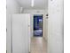 Hallway with tile flooring, a refrigerator and a view of a blue painted back door at 7841 Royal Stewart Dr, New Port Richey, FL 34653