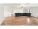 Large living room features hardwood floors, a ceiling fan and lots of space at 7841 Royal Stewart Dr, New Port Richey, FL 34653