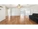 Spacious living room featuring beautiful hardwood floors and a ceiling fan at 7841 Royal Stewart Dr, New Port Richey, FL 34653