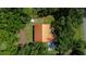 An aerial view of a home nestled among mature trees at 8600 Shenandoah Run, Wesley Chapel, FL 33544