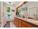 Bathroom with double sinks, wood cabinets and a large framed mirror at 8600 Shenandoah Run, Wesley Chapel, FL 33544