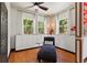 Bedroom featuring a comfortable blue chaise lounge and built in cabinets, with views of the surrounding nature at 8600 Shenandoah Run, Wesley Chapel, FL 33544