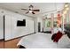 Bedroom with stylish built-in cabinets, a sleek TV, and a comfortable chaise lounge area at 8600 Shenandoah Run, Wesley Chapel, FL 33544