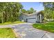 Charming single-story home featuring a well-maintained lawn and a paved driveway at 8600 Shenandoah Run, Wesley Chapel, FL 33544