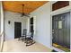 Cozy front porch with ceiling fan, rocking chairs and front door at 8600 Shenandoah Run, Wesley Chapel, FL 33544