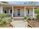 Inviting front porch with ceiling fans, rocking chairs, and wood accents at 8600 Shenandoah Run, Wesley Chapel, FL 33544