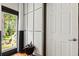 An interior hallway featuring paneled walls and a view to the backyard at 8600 Shenandoah Run, Wesley Chapel, FL 33544