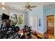 A dedicated home gym with wood flooring, featuring exercise equipment and a bright window view at 8600 Shenandoah Run, Wesley Chapel, FL 33544