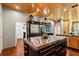 Open kitchen with stainless steel appliances, island, and direct view to living space at 8600 Shenandoah Run, Wesley Chapel, FL 33544