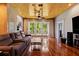 Bright living room with hardwood floors, backyard views, modern ceiling fan, and comfortable seating at 8600 Shenandoah Run, Wesley Chapel, FL 33544