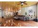 Open-concept living room with wood floors, a stone accent wall, and modern furniture at 8600 Shenandoah Run, Wesley Chapel, FL 33544