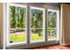 These large windows offer scenic views of the lush greenery surrounding the property at 8600 Shenandoah Run, Wesley Chapel, FL 33544