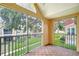 Charming screened-in balcony with tile flooring offering serene community views and natural light at 9481 Highland Oak Dr # 1506, Tampa, FL 33647
