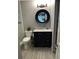 Chic bathroom featuring a black vanity with a marble countertop, modern mirror, and updated fixtures at 9481 Highland Oak Dr # 1506, Tampa, FL 33647