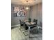 Modern dining room with a glass-top table, stylish chairs, contemporary lighting, and unique wall art at 9481 Highland Oak Dr # 1506, Tampa, FL 33647