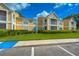 Inviting condo complex featuring well-maintained landscaping, yellow facades, and white accents under a bright blue sky at 9481 Highland Oak Dr # 1506, Tampa, FL 33647
