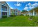 Beautiful condo building with a spacious green lawn and well-maintained landscaping on a sunny day at 9481 Highland Oak Dr # 1506, Tampa, FL 33647