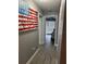 Hallway leading to a bedroom featuring decorative wall art and a view of a comfortable sleeping area at 9481 Highland Oak Dr # 1506, Tampa, FL 33647
