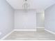 Bright living area with stylish chandelier and light wood-look flooring at 9481 Highland Oak Dr # 1506, Tampa, FL 33647