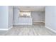 Open-concept living and kitchen area featuring modern gray floors and neutral color palette at 9481 Highland Oak Dr # 1506, Tampa, FL 33647