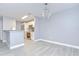 Open-concept living area showcasing modern lighting and flowing into the kitchen at 9481 Highland Oak Dr # 1506, Tampa, FL 33647