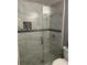 Sleek, modern shower with glass door, elegant tiling, and a convenient built-in niche for toiletries at 9481 Highland Oak Dr # 1506, Tampa, FL 33647