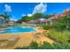 Community swimming pool and deck with lounge chairs and nearby residential buildings at 9481 Highland Oak Dr # 1506, Tampa, FL 33647