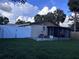 Well-maintained backyard with a patio, privacy fence, and mature trees at 10102 Missy Ct, Tampa, FL 33615