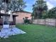 Spacious backyard with a patio area, lush lawn, and privacy fence at 10102 Missy Ct, Tampa, FL 33615
